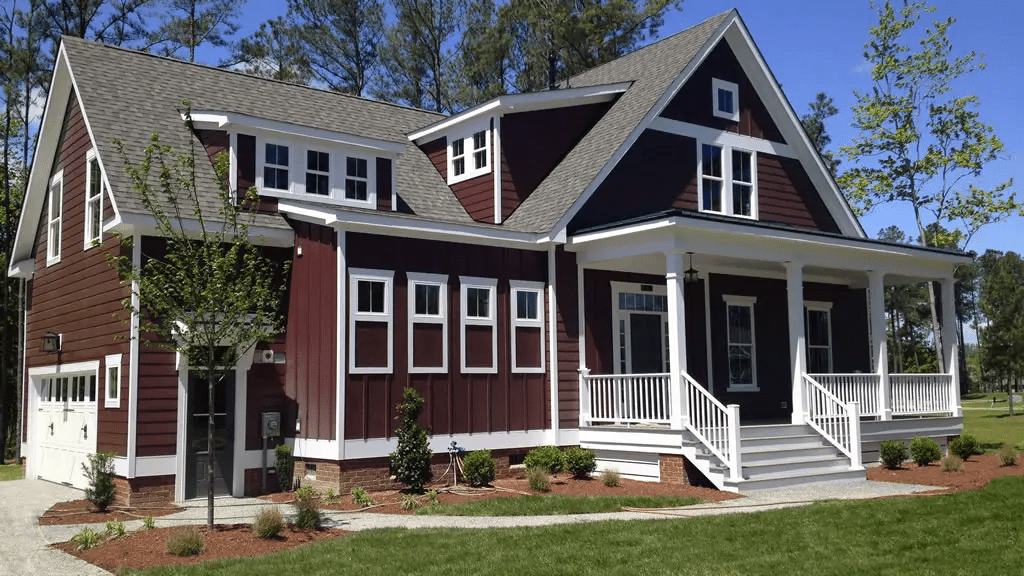 A red house with a light grey roof and white windows