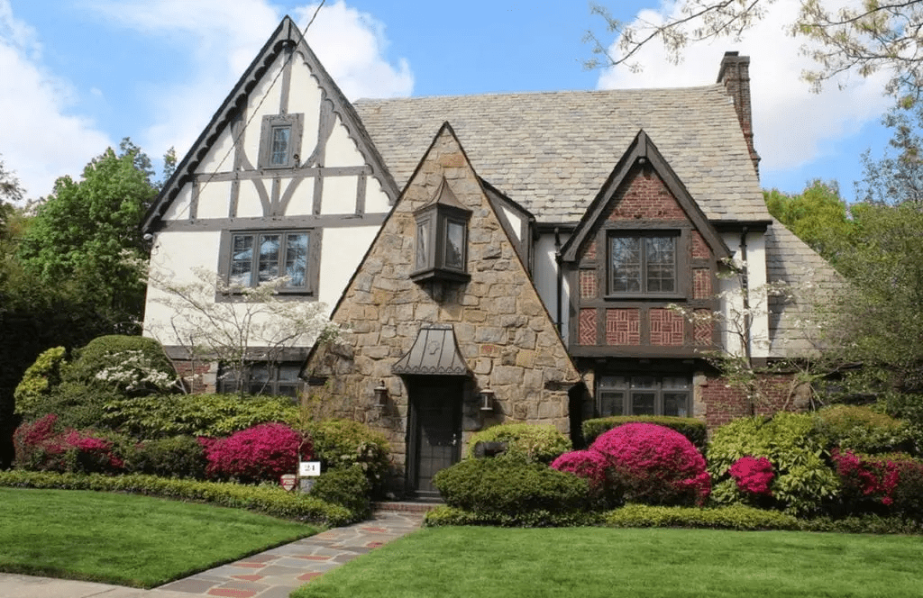 A tudor style home with brick and wooden enhancements 