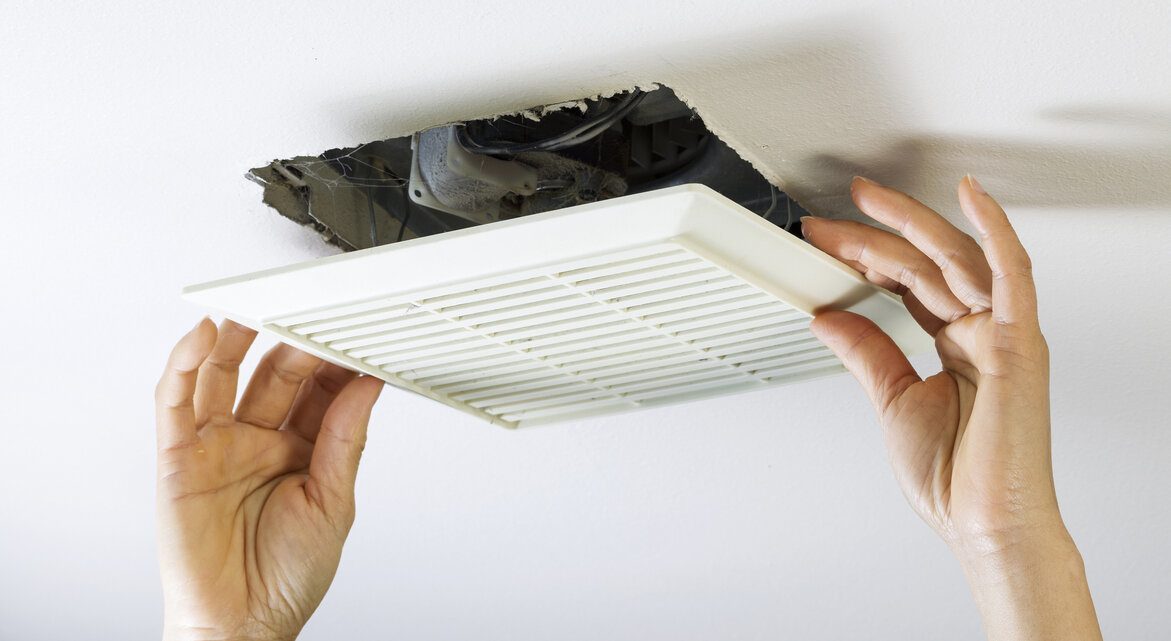 Professional removing bathroom air duct cover from ceiling