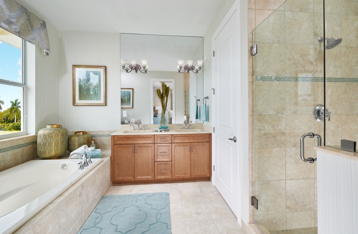 Beach Bathroom With Wooden Cabinets, a Mirror, and a Tub