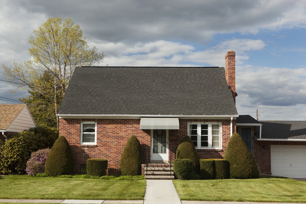 Red Brick Bungalow With a Beautiful Green Front Yard