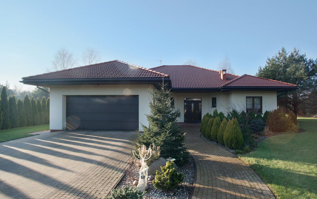 Bungalow With a Tiled Roof and an Attached Garage