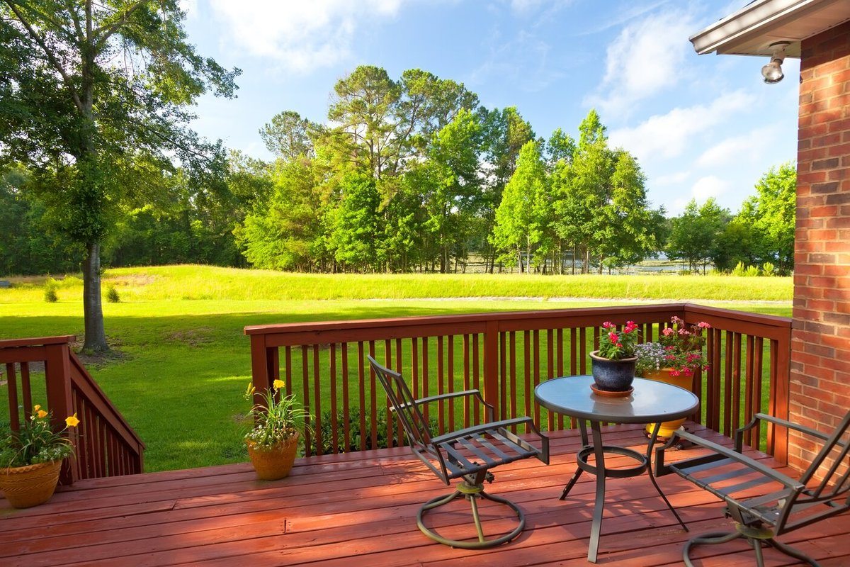 Beautiful outdoor wooden deck with access to garden