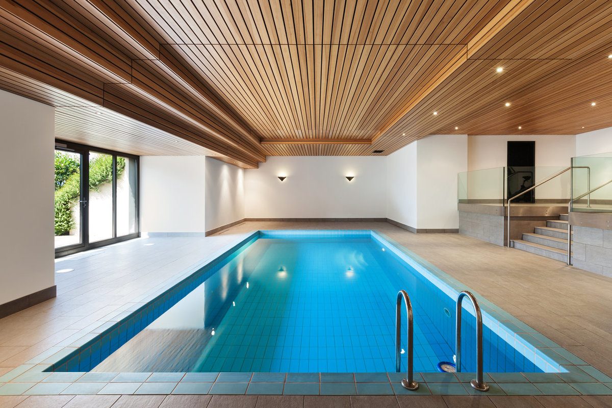 Indoor in-ground swimming pool inside a dedicated room of the house