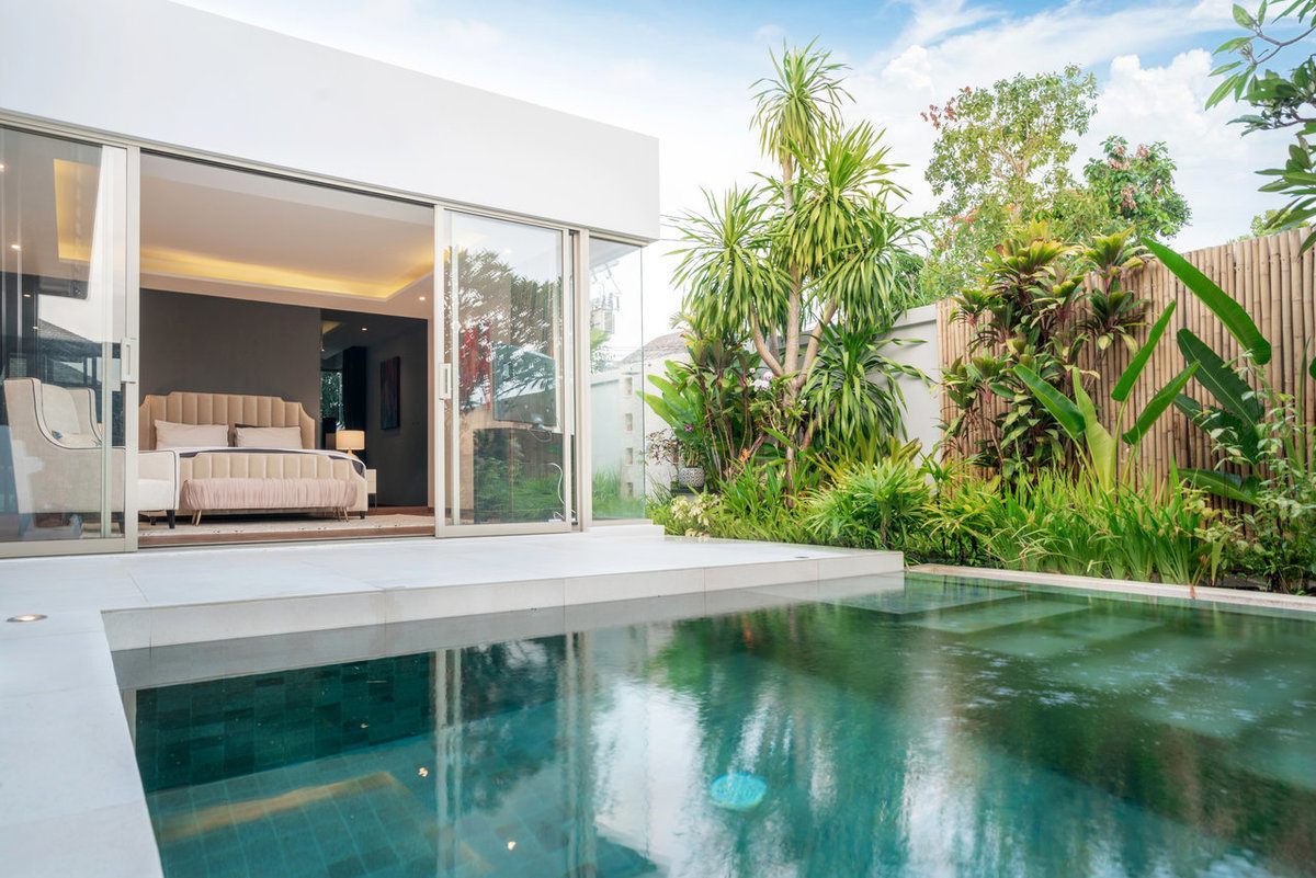 Salt water pool built in a backyard with a concrete deck