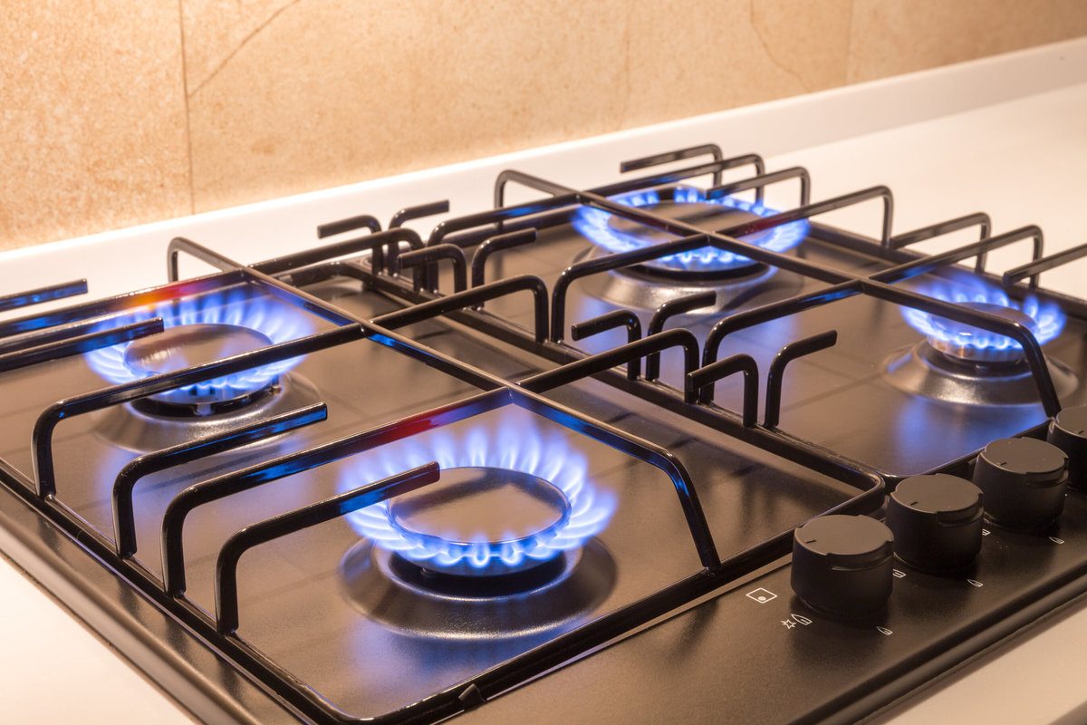 Gas burner on a black kitchen stove