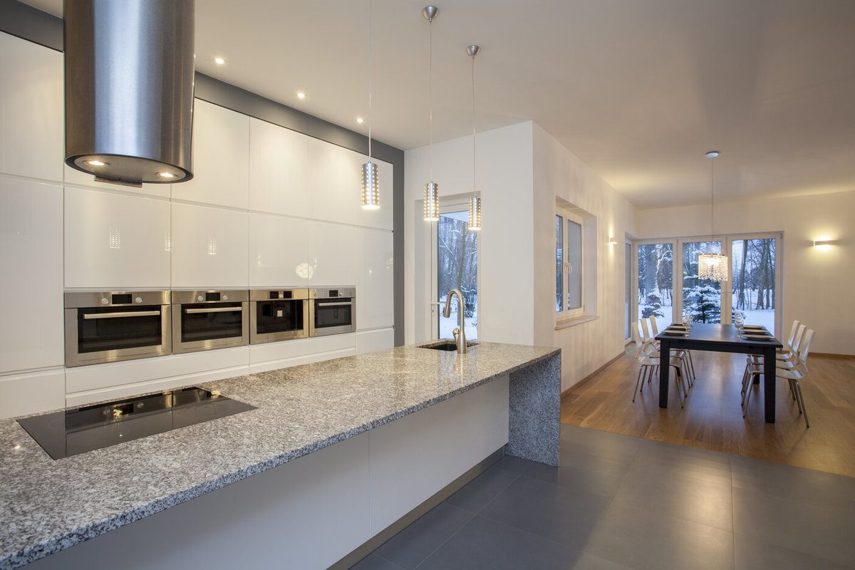 Open Space Kitchen With a Quartz Countertop and White Cabinets