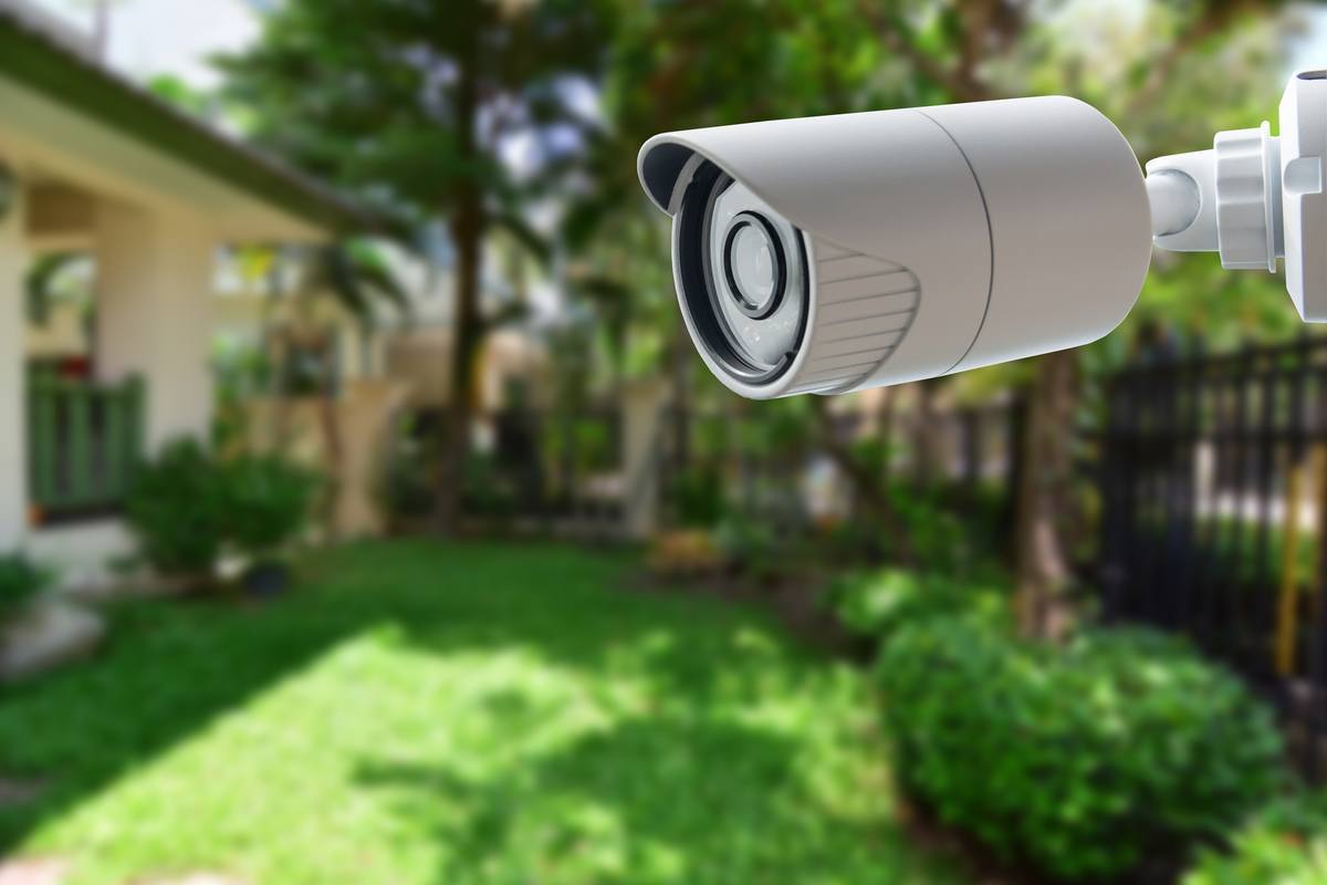 Outdoor security camera installed in a house garden