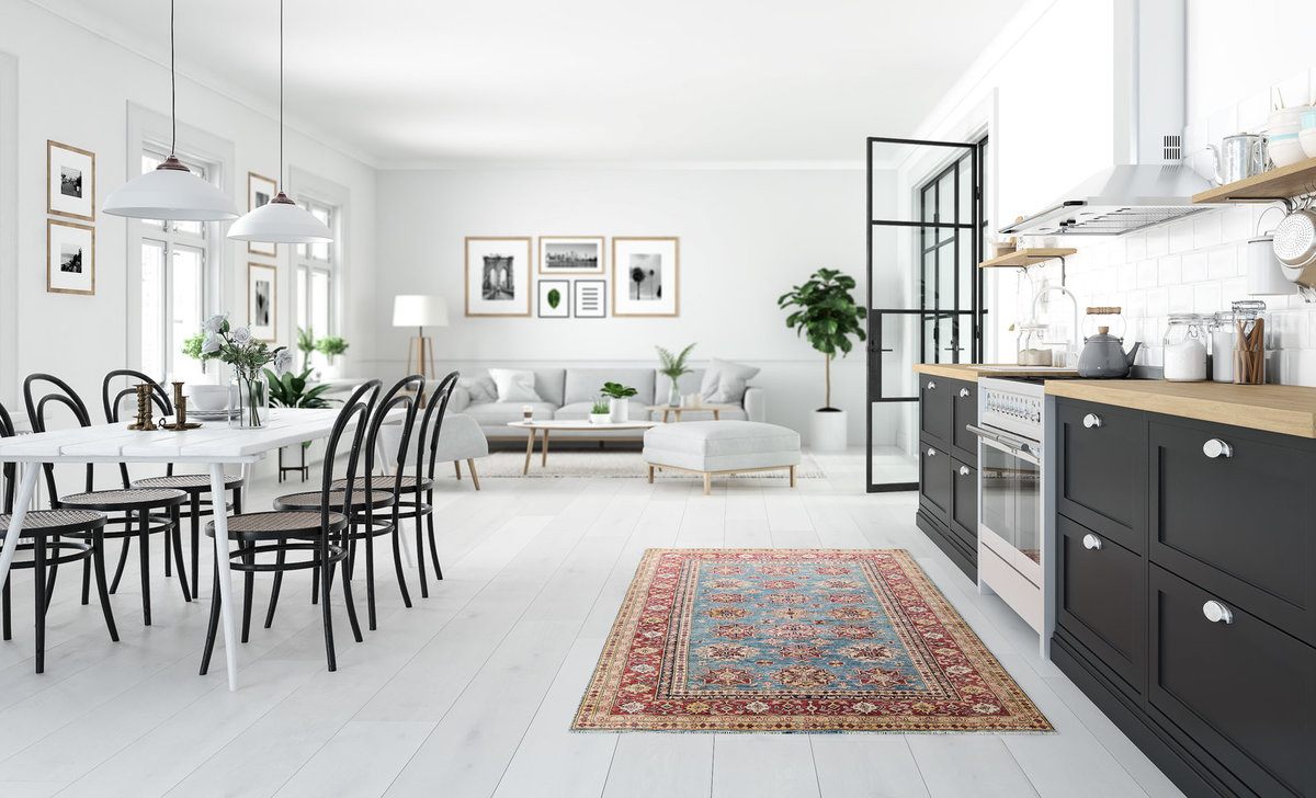 Scandinavian Kitchen Design with Colorful Rug and White Table with Brown Chairs