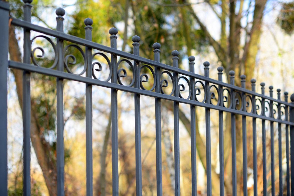 Decorative cast metal wrought fence with artistic forging