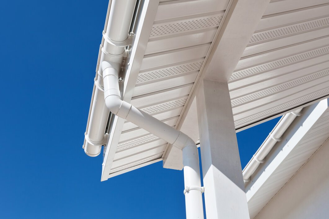 Large White Roof Eaves with Gutters and Downspout Attached