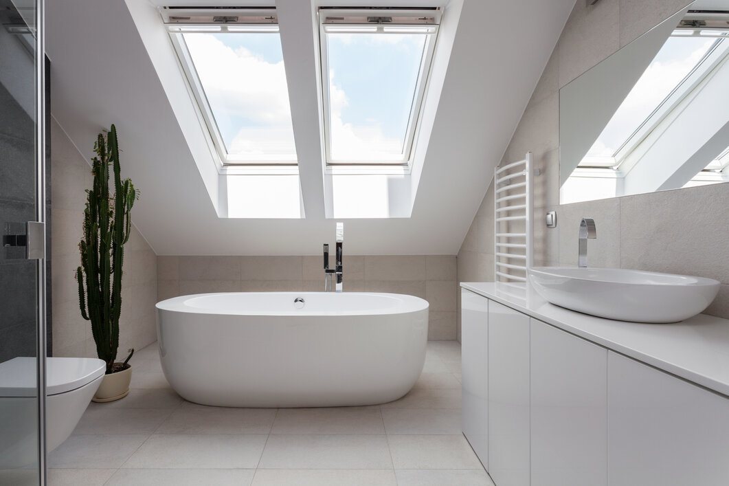 Beautiful Skylight in a White Bathroom With a Porcelain Freestanding Bath