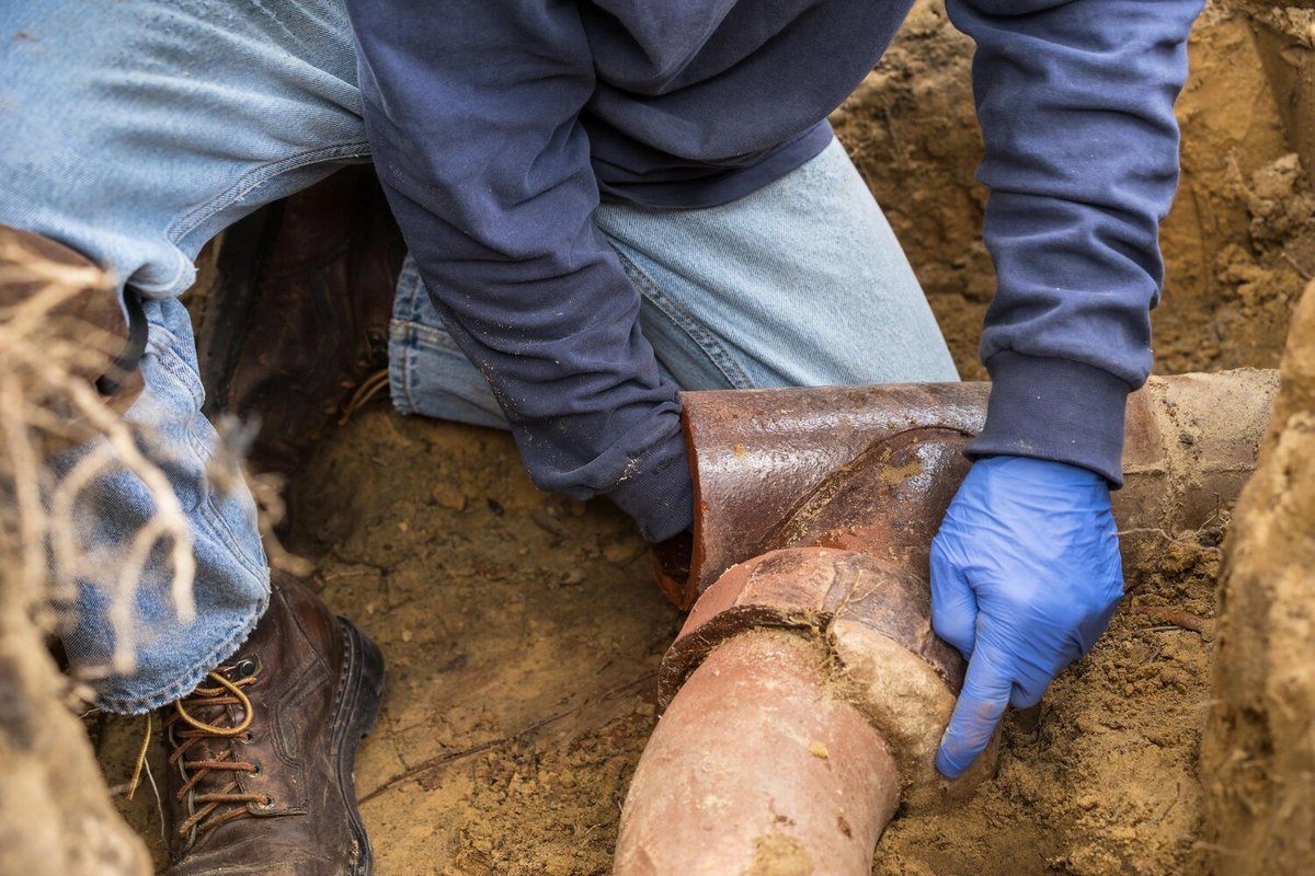 Plumber Unclogging Main Sewer Line