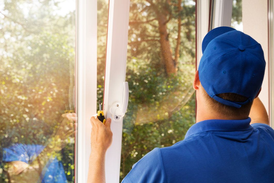 worker installing new vinyl windows